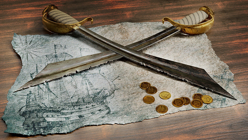 Décoration de table thème pirate : parchemin, épées, pièces